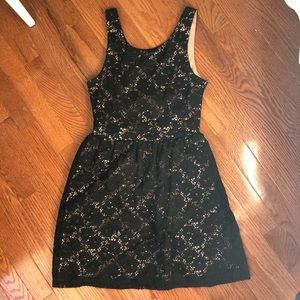 Black lace skater dress with a tan under skirt